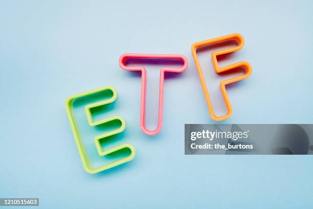 high angle view of etf letters on blue background, symbol of investment in stock market - exchange traded fund fotografías e imágenes de stock