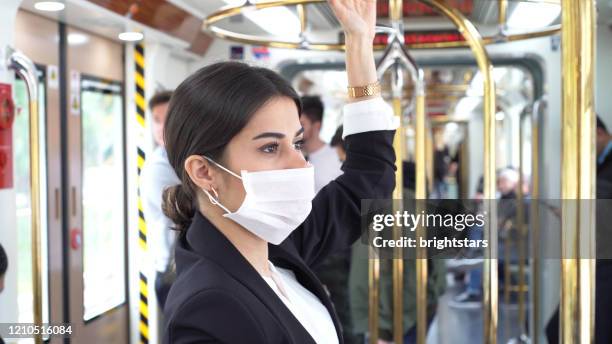 businesswoman wearing a mask while traveling - businesswoman mask stock pictures, royalty-free photos & images