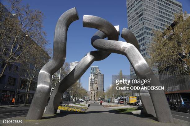 The place around the popular tourist landmark sculpture Broken chain by Kaiser Wilhelm memorial church is largely deserted in Berlin on April 21,...
