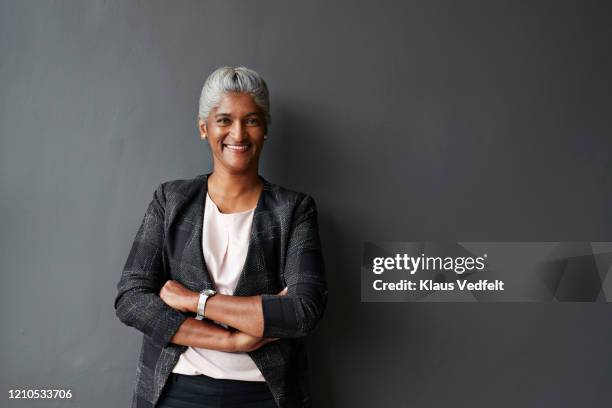 smiling businesswoman standing in board room - meeting board room stock pictures, royalty-free photos & images