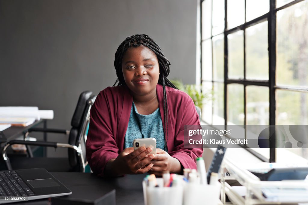 Entrepreneur using mobile phone at workplace