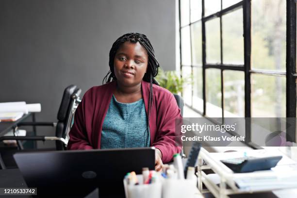 businesswoman using laptop at modern workplace - differing abilities female business stock-fotos und bilder