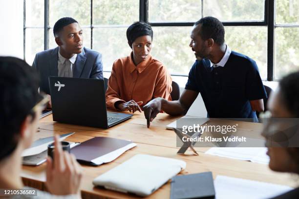 entrepreneurs discussing in board meeting - business people group brown stock pictures, royalty-free photos & images