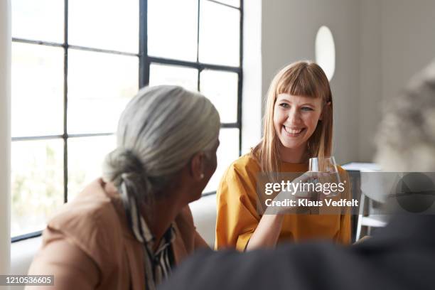 businesswoman with water by coworker at workplace - differential focus stock pictures, royalty-free photos & images