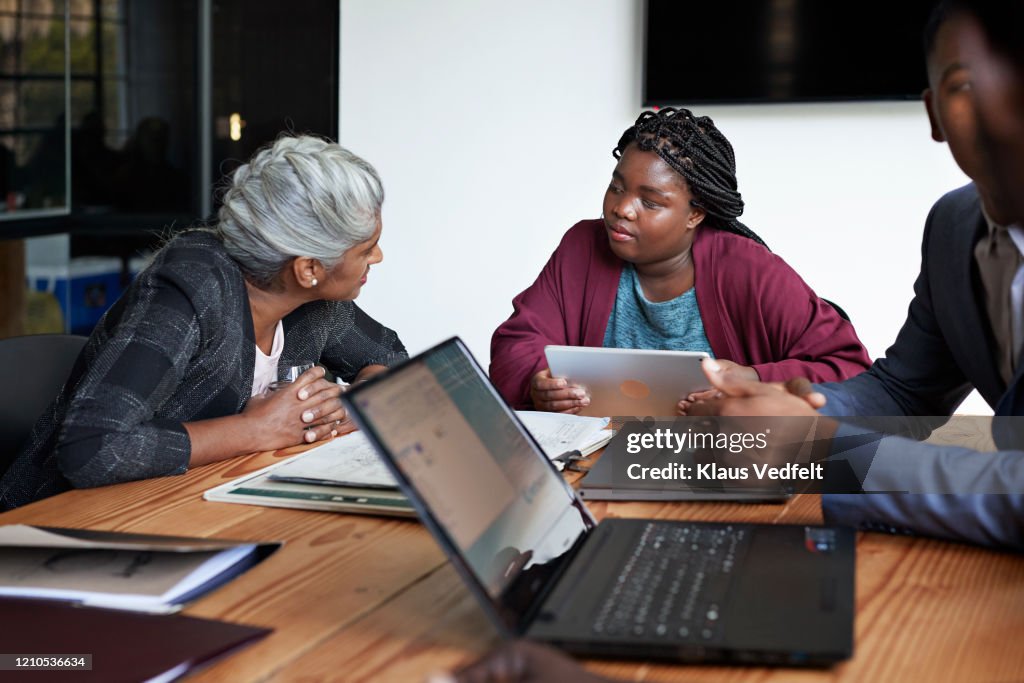 Businesswoman and colleague discussing in office