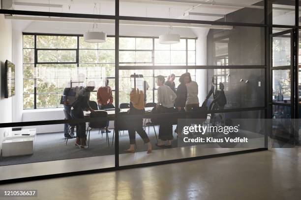 executives getting settled for meeting in office - farewell colleague stock pictures, royalty-free photos & images