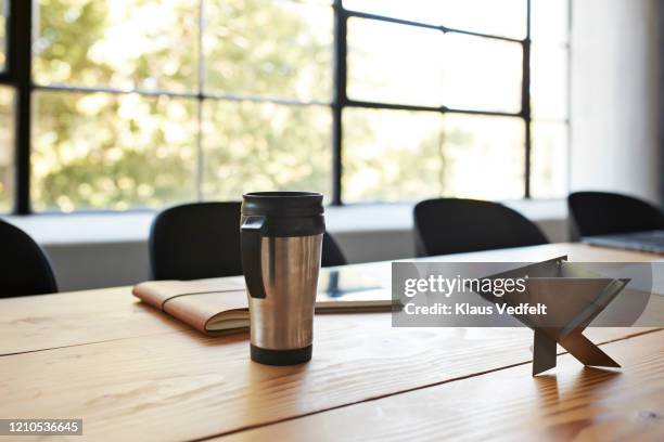 travel mug on conference table in board room - flask imagens e fotografias de stock