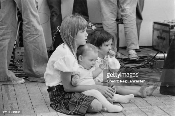 Heather McCartney holds her sister, Stella McCartney, and Mary McCartney, daughters of Paul McCartney and Linda McCartney, as they watch their...