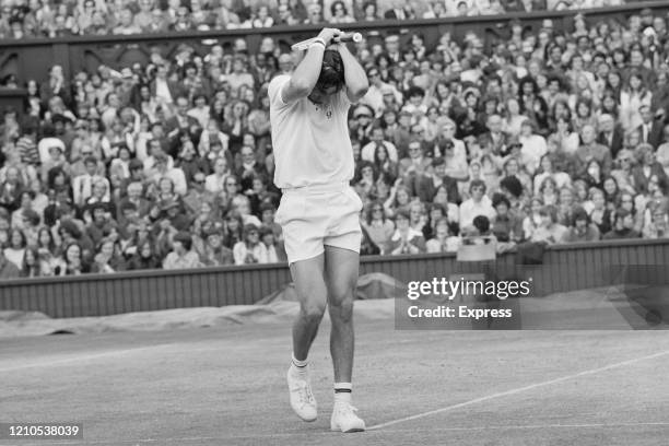 Romanian tennis player Ilie Nastase holds his head in despair during the Men's Singles Final against the United States' Stan Smith at the 1972...