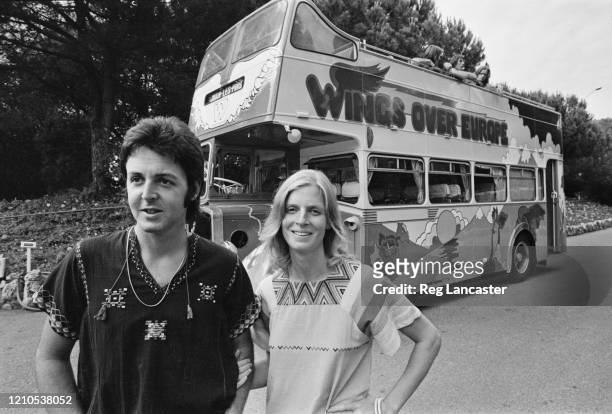 British singer and musician Paul McCartney and American photographer and musician Linda McCartney in front of the converted bus in which their band...