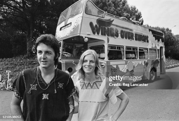 British singer and musician Paul McCartney and American photographer and musician Linda McCartney in front of the converted bus in which their band...