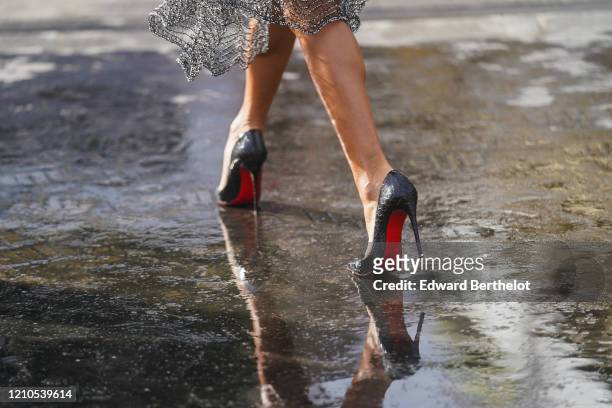 Black and red Louboutin high heel shoes are seen outside Chanel, during Paris Fashion Week - Womenswear Fall/Winter 2020/2021 on March 03, 2020 in...