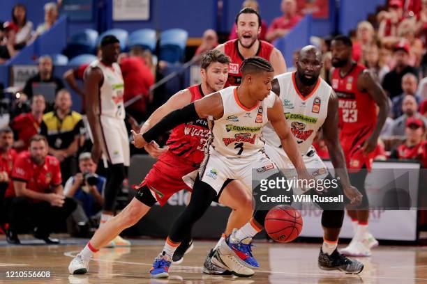 Scott Machado of the Taipans tries to drive past the defense of Damian Martin of the Wildcats during game three of the NBL Semi Final Series between...