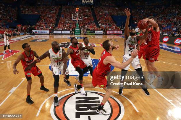 Damian Martin of the Wildcats strips the ball of DJ Newbill of the Taipans during game three of the NBL Semi Final Series between the Perth Wildcats...