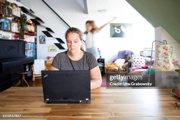 In this photo illustration a child disturbs the mother at work on April 16, 2020 in Bonn, Germany. Because of the Corona lockdown people have to work...