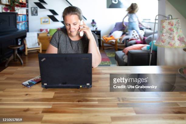In this photo illustration a child disturbs the mother at work on April 16, 2020 in Bonn, Germany. Because of the Corona lockdown people have to work...