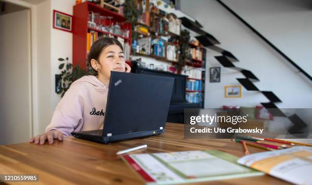 In this photo illustration a girl is overwhelmed in front of her laptop on April 15, 2020 in Bonn, Germany.