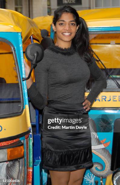 Actress Amara Karan poses alongside her "Darjeeling Limited" Tut-Tuts in Soho Square on November 21, 2007 in London, England.