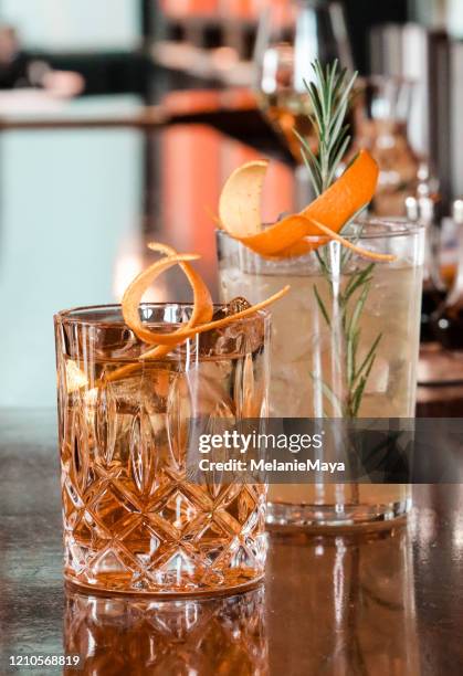 chic cocktails on bar counter - old fashioned whiskey stock pictures, royalty-free photos & images