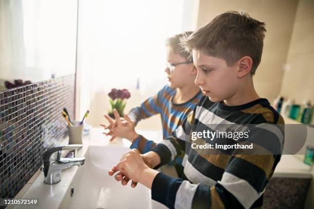 little boys washing hands thoroughly - disinfection school stock pictures, royalty-free photos & images