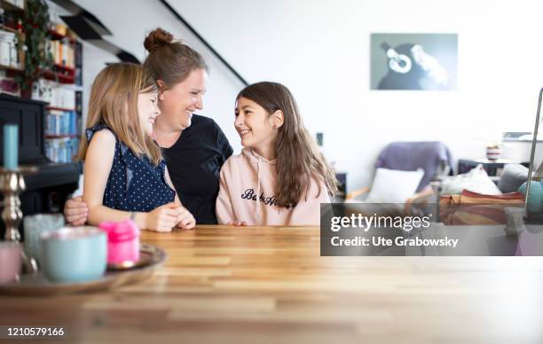 In this photo illustration a mother and her children are looking at each others on April 15, 2020 in Bonn, Germany.