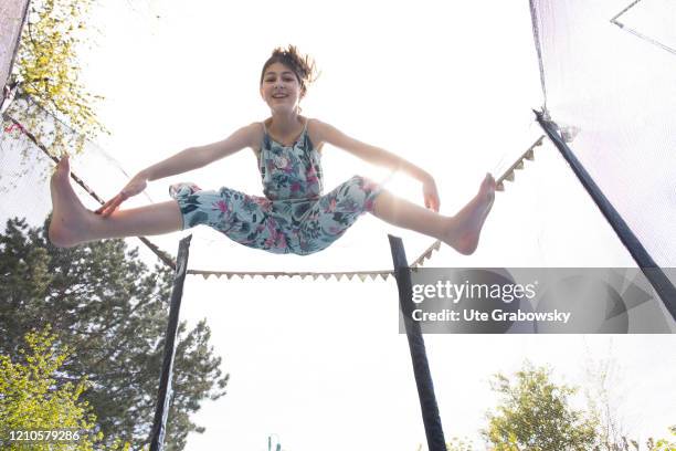 In this photo illustration a girl is jumping on a trampoline on April 15, 2020 in Bonn, Germany.