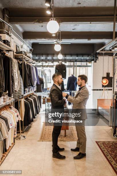 young man trying on a new suit - tailored suit stock pictures, royalty-free photos & images