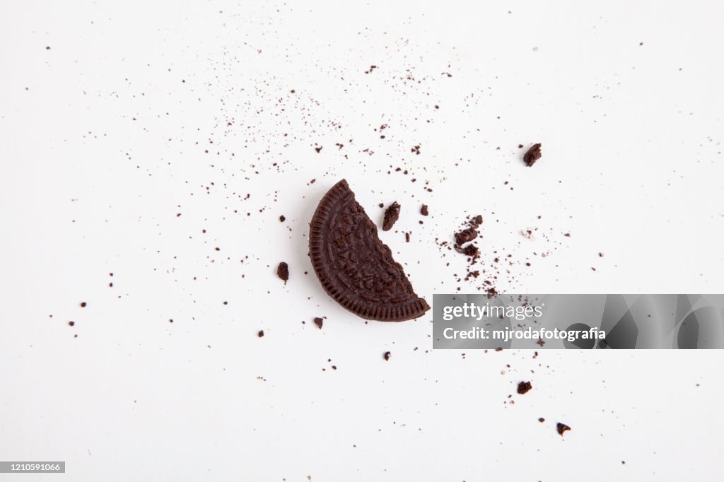 Chocolate sandwich cookie.  Half a broken cookie