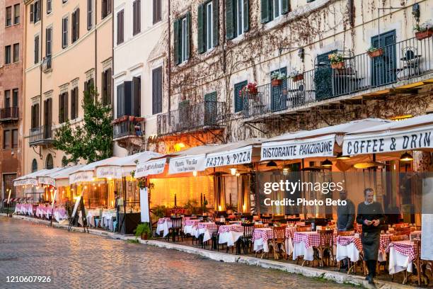 the restaurants in piazza navona in rome appear empty during the covid-19 health crisis - italian restaurant stock pictures, royalty-free photos & images
