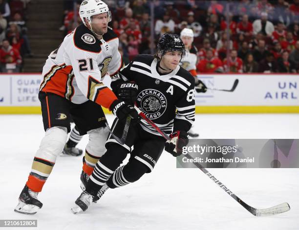 Patrick Kane of the Chicago Blackhawks skates to the puck under pressure from David Backes of the Anaheim Ducks at the United Center on March 03,...