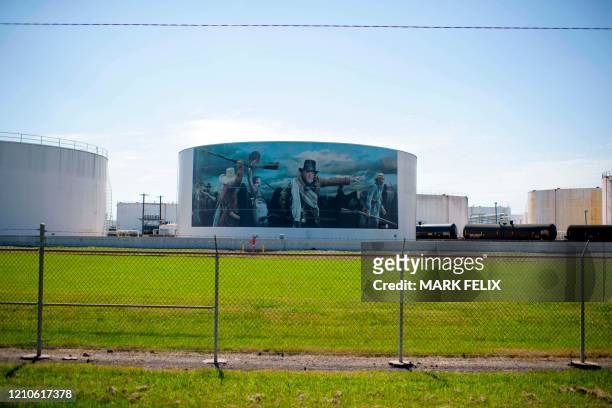 Mural with figures from Texas Revolution is featured on the side of an oil storage facility tank at the Vopak Terminal Deer Park on April 21, 2020 in...
