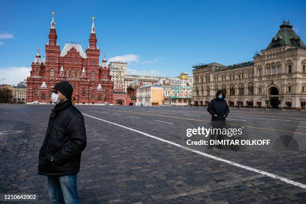 Security persons keep distance as Russian Communist party supporters take part in a flower-laying ceremony marking the 150th anniversary of the birth...