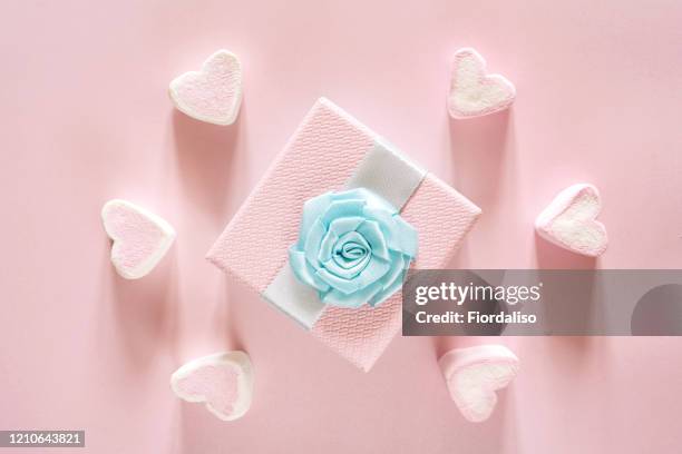 gift box of pastel pink color with candy sweet hearts, blue ribbon bow knitted flower - saint valentin stock pictures, royalty-free photos & images