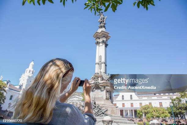 mature woman takes pic of cathedral, quito - quito stock pictures, royalty-free photos & images