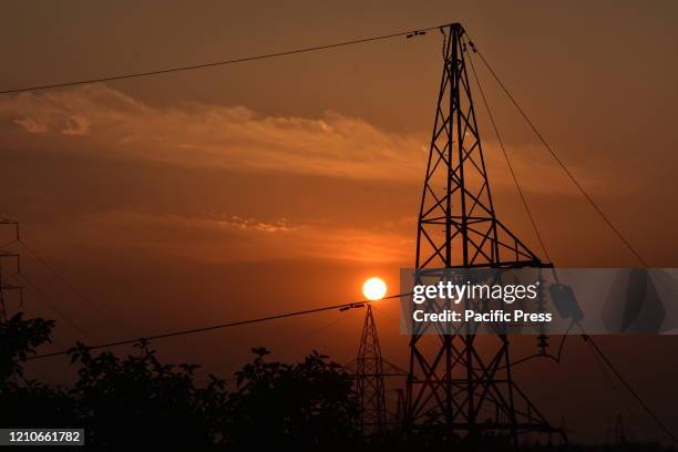 Sun setting behind electricity pylons on the 50th anniversary of the Earth Day with the theme Climate Action in an unprecedented nationwide lockdown...