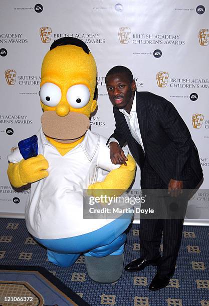 Shaun Wright Phillips and Homer Simpson pose for pictures in the Press Room of 12th British Academy Children's Awards at the London Hilton Park Lane...