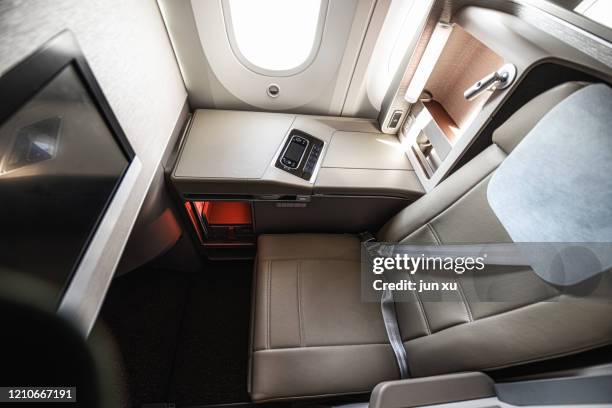 luxurious seats inside the plane - first class plane stock-fotos und bilder