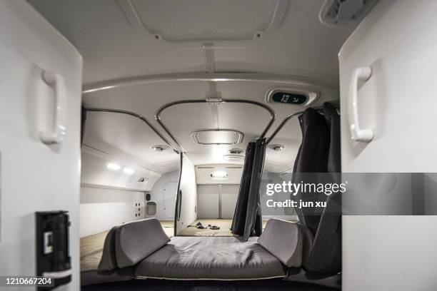 the cabin attendant's resting bed on the plane - economy class stock-fotos und bilder