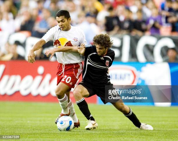 United's Ben Olsen gets an arm in front of New York Red Bull's Amado Guevara at RFK Stadium in Washington, D.C. On Sunday, April 2, 2006. The Red...