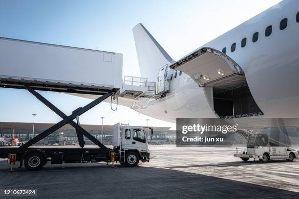 the airport is loading the plane with supplies - airport cargo stock pictures, royalty-free photos & images