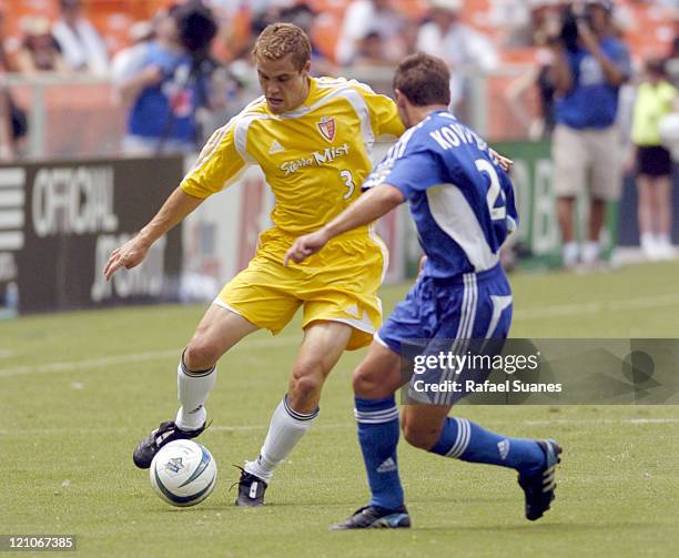 Western Conference defender Chris Albright tries to drive past Dema Kovaleko at RFK Stadium on July 31, 2004. The Eastern Conference defeated the...