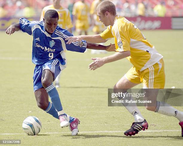 Freedy Adu battles Brian Ching at RFK Stadium on July 31, 2004 during the MLS All-Star game. The Eastern Conference defeated the West, 3-2.