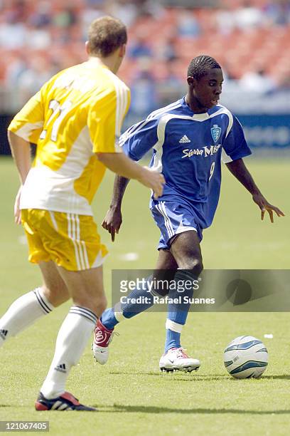 Freddy Adu drives past Jimmie Conrad at RFK Stadium on July 31, 2004. The Eastern Conference defeated the West, 3-2.