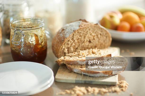 freshly sliced bread and jam in zero waste kitchen. - sliced loaf stock pictures, royalty-free photos & images