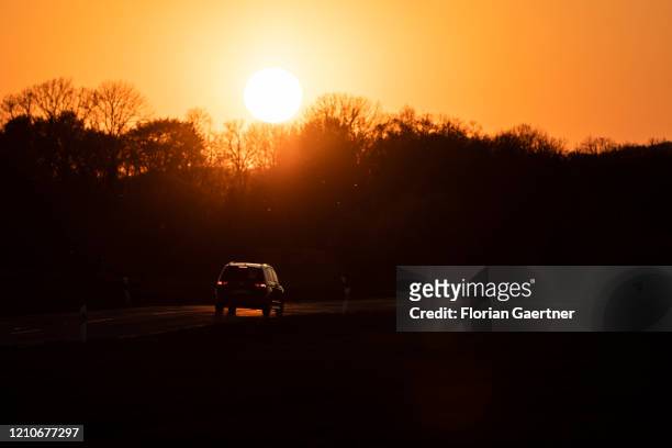 Car is pictured during sunset on a country road on April 22, 2020 in Koenigshain, Germany.