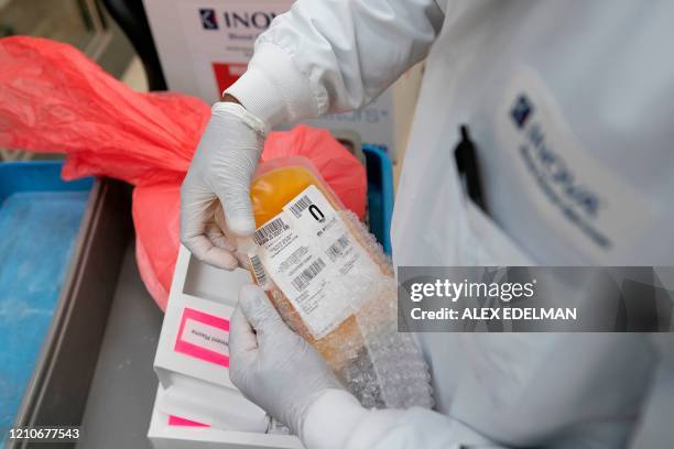 Lab technician freeze packs donated convalescent plasma donated by recovered COVID-19 patients for shipping to local hospitals at Inova Blood...