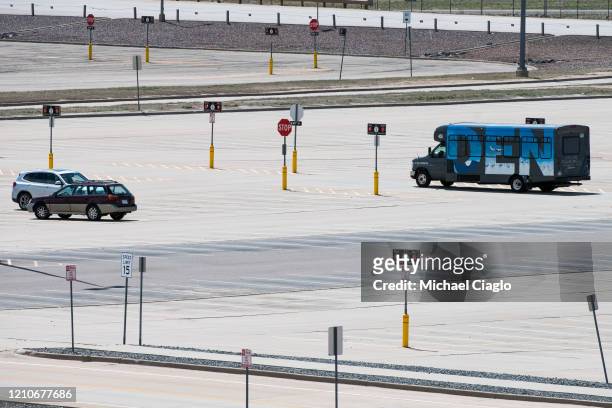Denver International Airport shuttle drives through an empty parking lot as the coronavirus pandemic slows air travel on April 22, 2020 in Denver,...