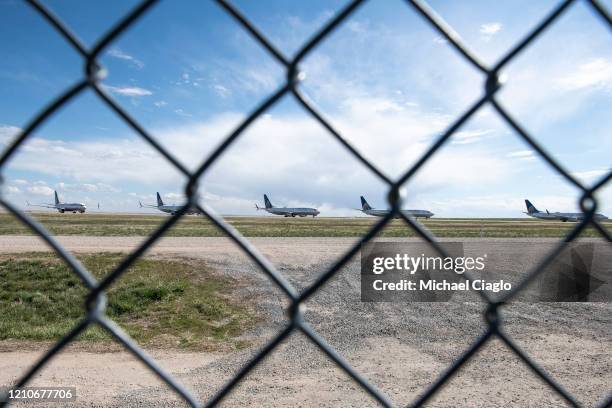 United Airlines planes sit parked on a runway at Denver International Airport as the coronavirus pandemic slows air travel on April 22, 2020 in...