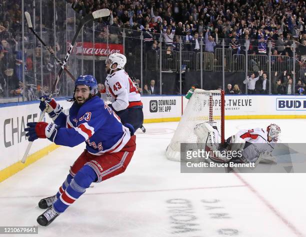 Mika Zibanejad of the New York Rangers scores his fifth goal of the game in overtime to defeat Ilya Samsonov and the Washington Capitals 5-4 at...