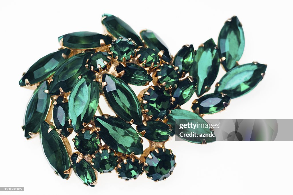 Vintage emerald green brooch isolated on a white background
